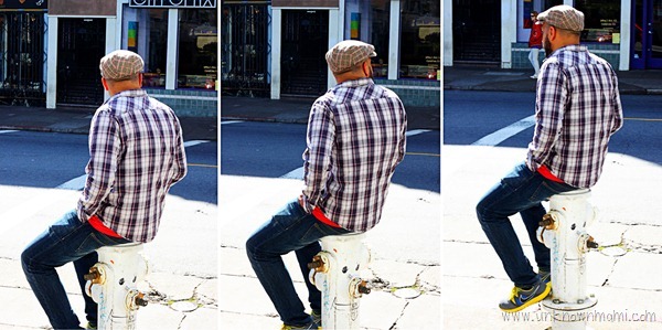 Man sitting on fire hydrant